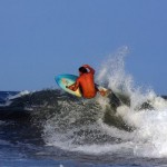 Donavon surfing on a Jay Alders art surfboard