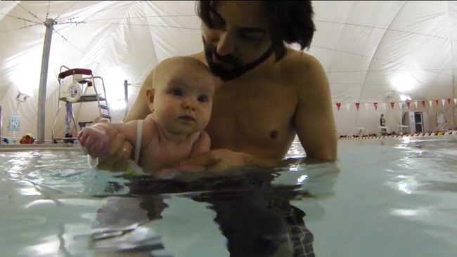 Surf artist Jay Alders and his daughter, Summer, during her first swim lesson.