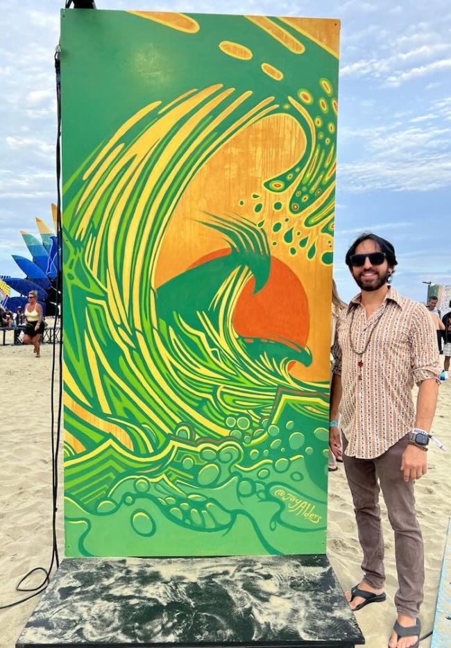 Jay Alders' modern mural at Sea Hear Now 2023, featuring an elongated surfer on a dynamic wave, vibrant in color and emotion